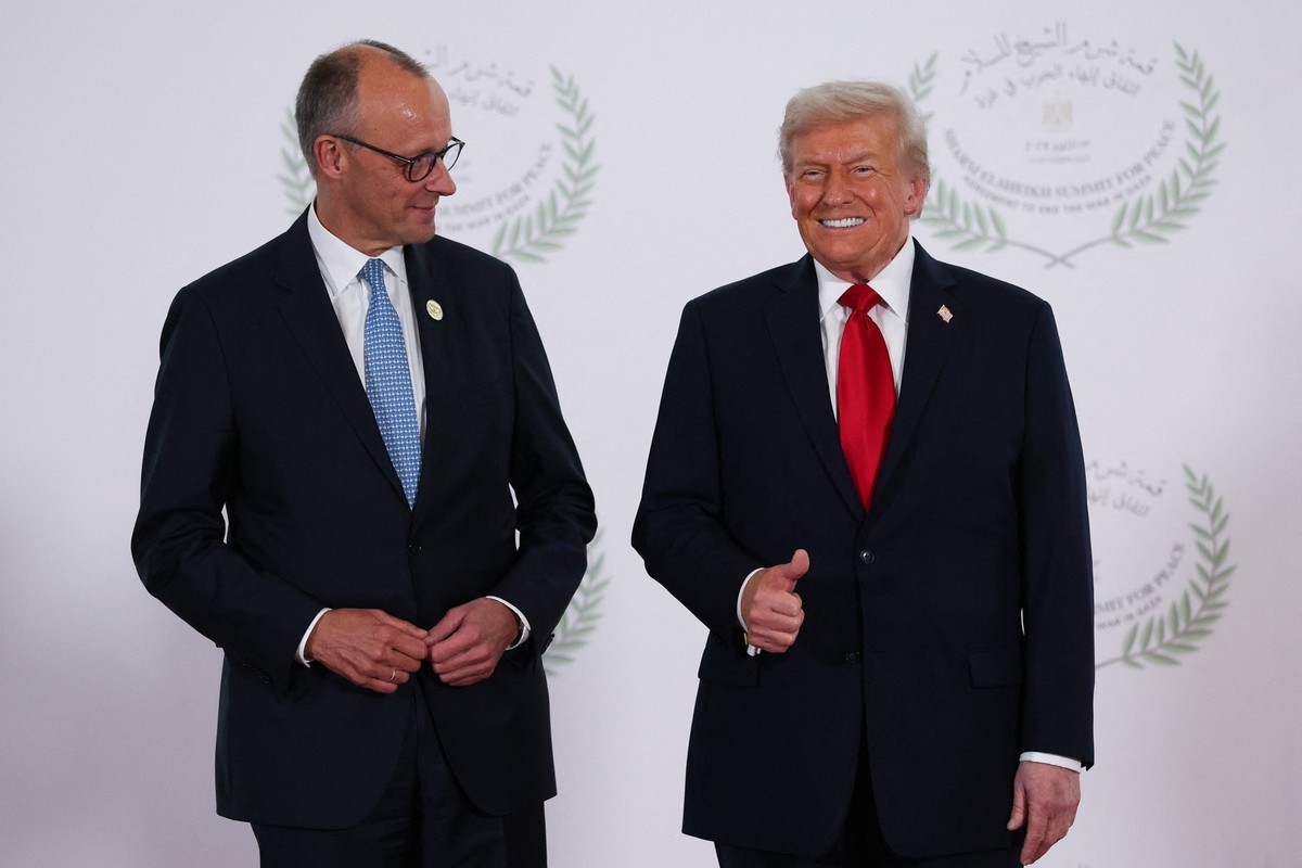 President Donald Trump and German Chancellor Friedrich Merz pose for a photo at a world leaders&#039; summit on ending the Gaza war, in Sharm el-Sheikh, Egypt, Monday, Oct. 13, 2025. (Suzanne Plunkett ...