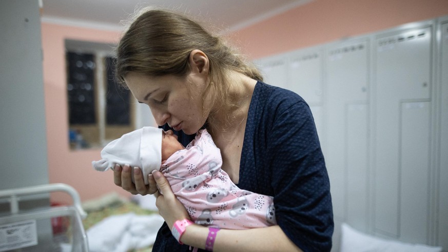 A mom kisses her Newborn baby ( Born during the War ) in the bomb shelter of a maternity hospital on March 03, 2022 in Kyiv, Ukraine. Russian forces continued their advance on the Ukrainian capital fo ...