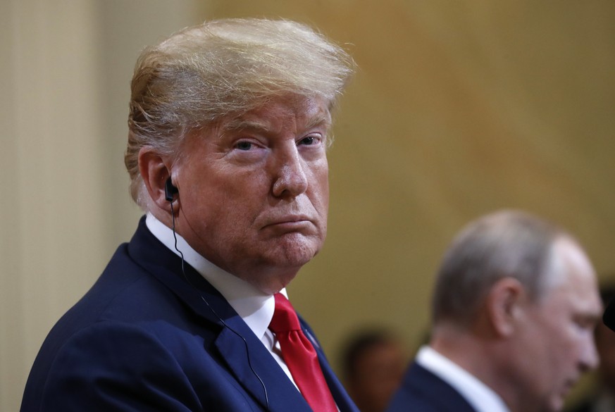 U.S. President Donald Trump listens to Russian President Vladimir Putin during a press conference after the meeting of U.S. President Donald Trump and Russian President Vladimir Putin at the President ...