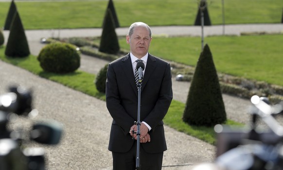 German Finance Minister Olaf Scholz addresses the media during a two-day retreat at the government guest house Meseberg castle in Gransee north of Berlin, Germany, Tuesday, April 10, 2018. (AP Photo/M ...