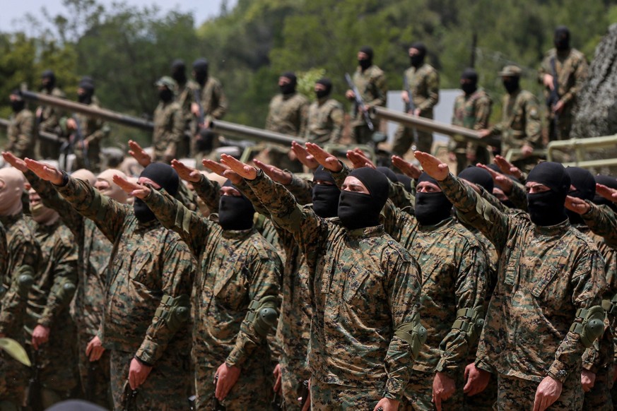 ARCHIV - 21.05.2023, Libanon, Aramta: Pro-iranische Hisbollah-Kämpfer legen während einer inszenierten Militärübung in einem Lager im südlibanesischen Dorf Aramta einen Eid ab. Die Schiitenorganisatio ...