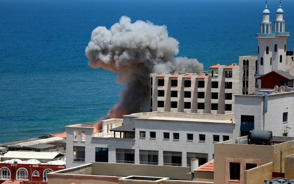 Palestine Israel Conflict Smoke billows from the port of Gaza following an Israeli naval bombardment on May 17, 2021. - Israeli air strikes hammered the Gaza Strip after a week of violence that has ki ...