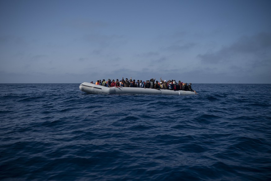 Refugees and migrants wait to be rescued by members of the Spanish NGO Proactiva Open Arms, after leaving Libya trying to reach European soil aboard an overcrowded rubber boat, north of Libyan coast,  ...