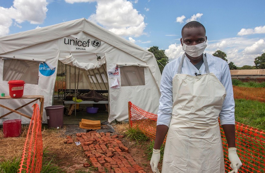TOPSHOT - A medical personnel stands in front of a ward of a Cholera Treatment Centre, funded by the Unicef, Malawi Red Cross and UK Aid, at Bwaila Hospital in the capital Lilongwe, Malawi, January 25 ...