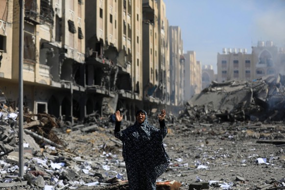 240314 -- BEIJING, March 14, 2024 -- A woman reacts in front of the rubble after Israeli strikes in the southern Gaza Strip city of Khan Younis, on March 13, 2024. The Palestinian death toll due to th ...