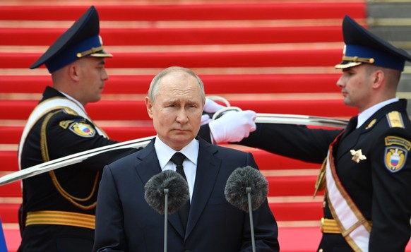 FILE - Russian President Vladimir Putin arrives to address units of the Defense Ministry, the National Guard, the Interior Ministry, the Federal Security Service and the Federal Guard Service at the K ...