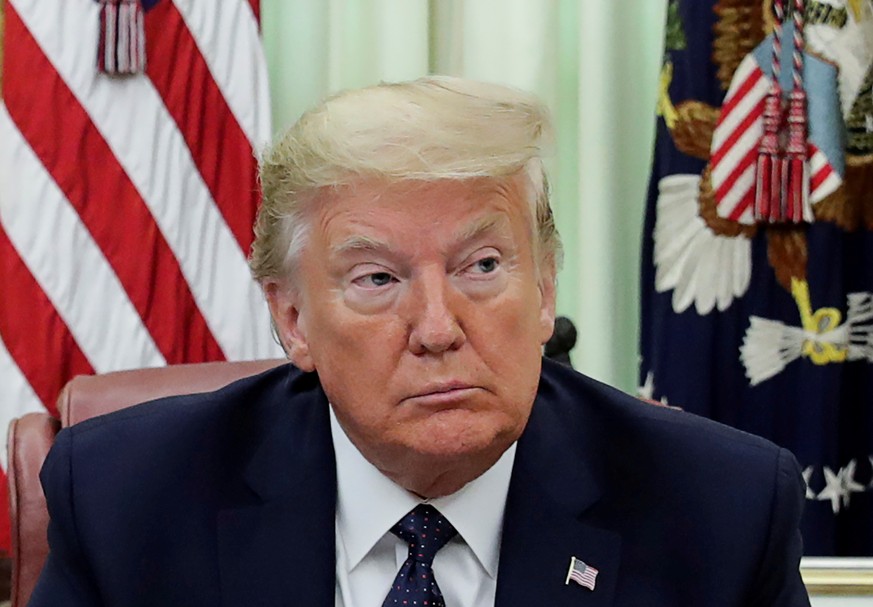 FILE PHOTO: U.S. President Donald Trump is seated prior to signing an executive order regarding social media companies in the Oval Office of the White House in Washington, U.S., May 28, 2020. REUTERS/ ...