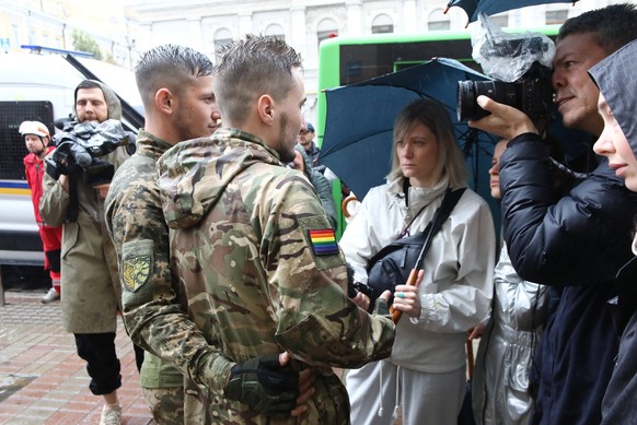KYIV, UKRAINE - JUNE 16, 2024 - Two Ukrainian servicemen speak to the press during the Equality March organised by KyivPride NGO for the first time since the 2022 Russian invasion of Ukraine, Kyiv, ca ...
