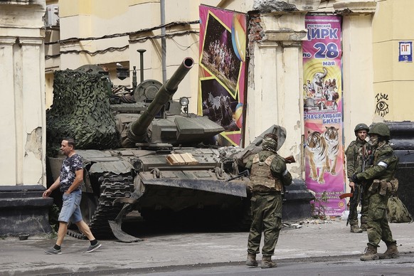 FILE - Members of the Wagner Group military company guard an area standing in front of a tank in a street in Rostov-on-Don, Russia, Saturday, June 24, 2023. A week after the mutiny raised the most dau ...