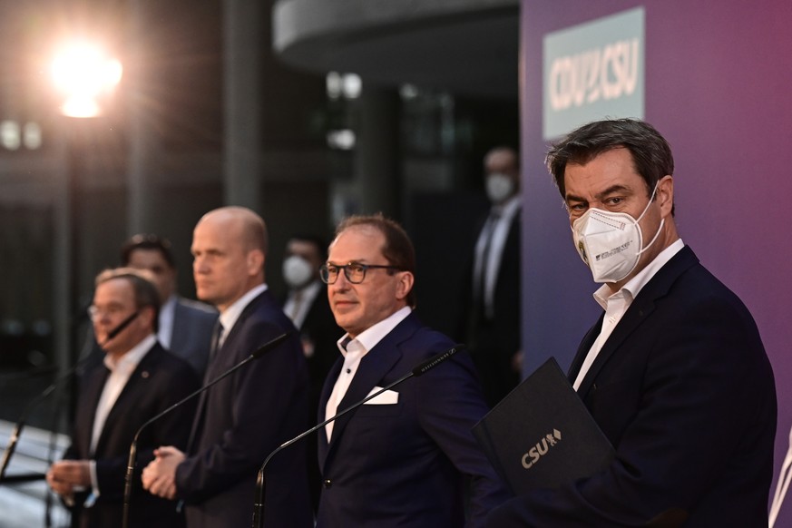 From left, the chairman of the German Christian Democratic Party (CDU), Armin Laschet, parliamentary group leader of the conservative CDU/CSU union, Ralph Brinkhaus, Christian Social Union (CSU) parli ...