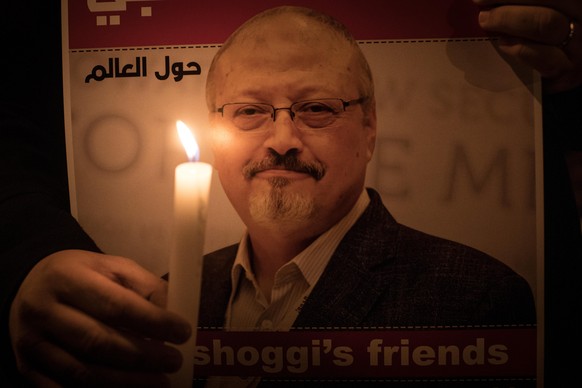 ISTANBUL, TURKEY - OCTOBER 25: People take part in a candle light vigil to remember journalist Jamal Khashoggi outside the Saudi Arabia consulate on October 25, 2018 in Istanbul, Turkey. Jamal Khashog ...