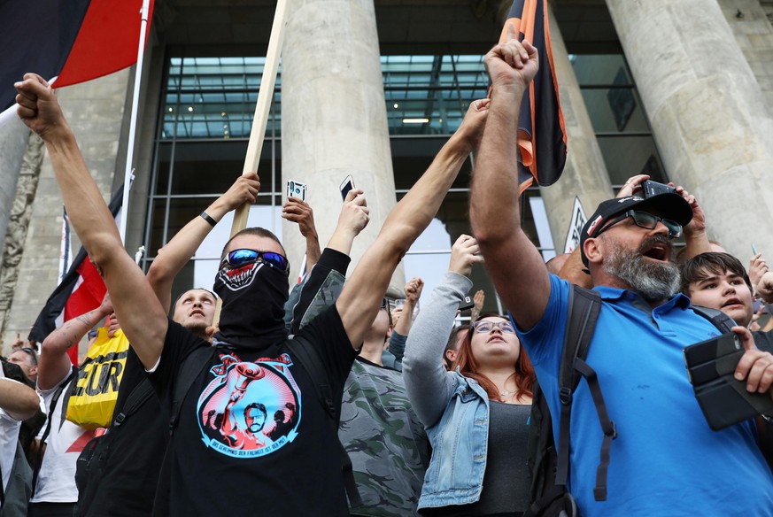 Demonstrators gesture in front of the Reichstag Building during a rally against the government&#039;s restrictions following the coronavirus disease (COVID-19) outbreak, in Berlin, Germany, August 29, ...