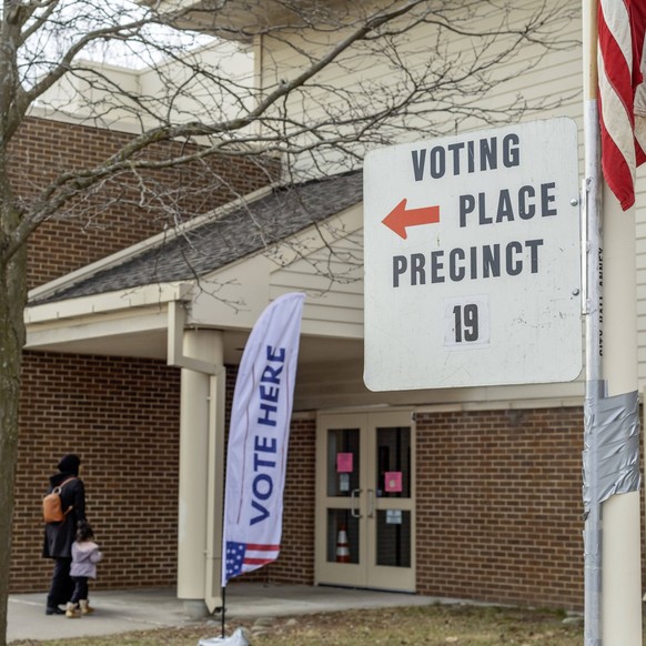 February 27, 2024, Deaarborn, Michigan, USA: Deaarborn, Michigan USA - 27 February 2024 - A voter and her child arrive to vote at Geer Park School in Michigan s Presidential primary election. Especial ...