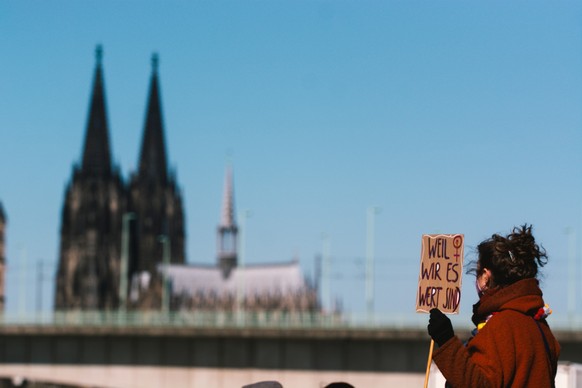 a protester hold a sign &amp;quot; because we have value&amp;quot; is seen during the day care workers strike in Cologne, Germany on March 8, 2022 (Photo by Ying Tang/NurPhoto via Getty Images)