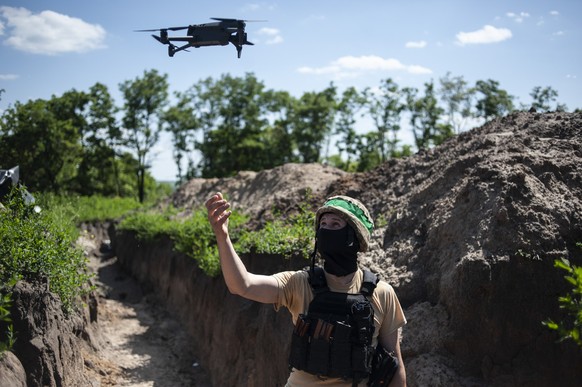 A Ukrainian soldier launches a drone from a trench in Chasiv Yar, the site of fierce battles with the Russian forces, Ukraine, Wednesday, June 7, 2023. (Iryna Rybakova via AP)