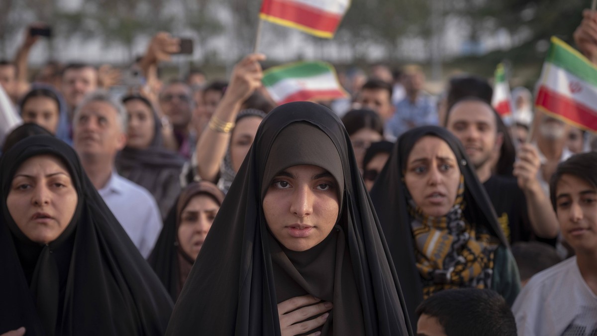 Daily Life In Tehran After Ceasefire Between Iran And Israel A young veiled Iranian woman stands at Azadi Square to watch a live concert in western Tehran, Iran, on June 25, 2025, as a ceasefire occur ...
