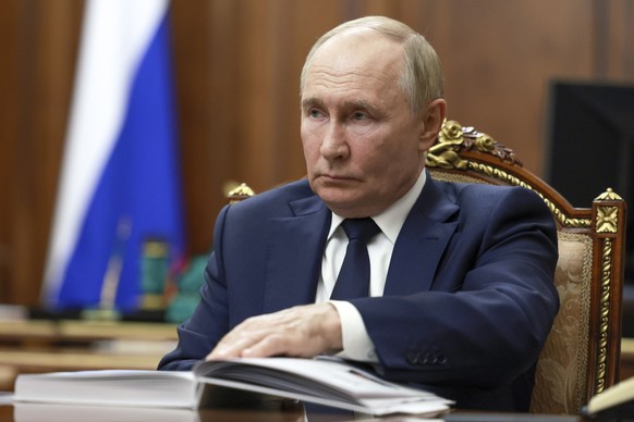 Russian President Vladimir Putin listens to Rostec State Corporation CEO Sergei Chemezov during their meeting at the Kremlin in Moscow, Russia, Tuesday, July 30, 2024. (Gavriil Grigorov, Sputnik, Krem ...