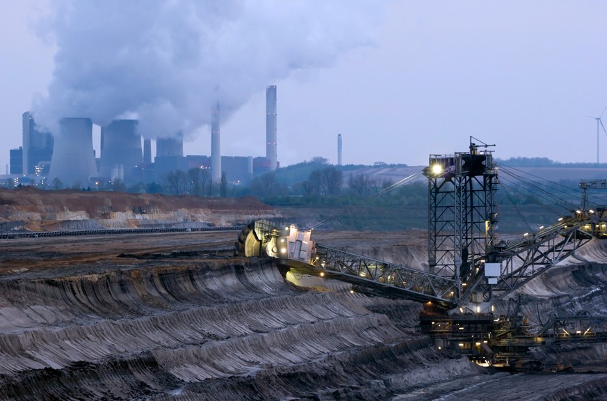 Large bucket wheel excavators in a lignite (brown-coal) mine after sunset, Germany