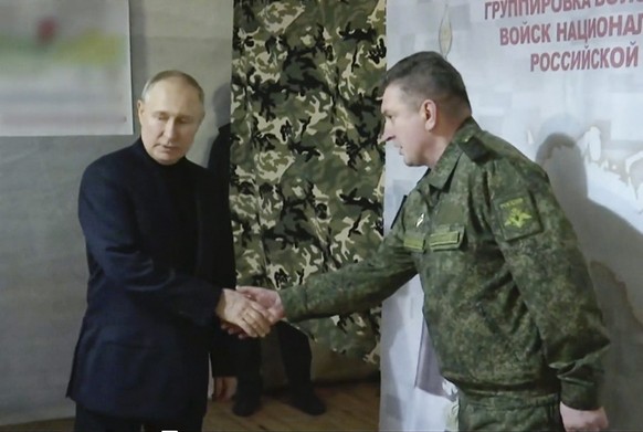 In this photo taken from video released by Russian TV Pool on Tuesday, April 18, 2023, Russian President Vladimir Putin meets with Col. Gen. Alexander Lapin during a visit to the headquarters of the n ...