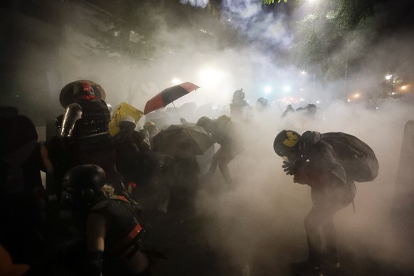 FILE - Federal officers launch tear gas at a group of demonstrators during a Black Lives Matter protest in Portland, Ore., on July 26, 2020. Residents of Portland, Oregon, will vote on a ballot measur ...
