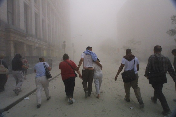 394261 50: Civilians flee as a tower of the World Trade Center collapses September 11, 2001 after two airplanes slammed into the twin towers in an alleged terrorist attack. (Photo by Mario Tama/Getty ...