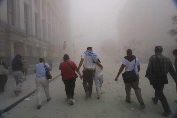 394261 50: Civilians flee as a tower of the World Trade Center collapses September 11, 2001 after two airplanes slammed into the twin towers in an alleged terrorist attack. (Photo by Mario Tama/Getty  ...