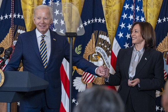 President Joe Biden, holds hands with Vice President Kamala Harris as he speaks at a reception in recognition of Black History Month in the East Room of the White House in Washington, Tuesday, Feb. 6, ...