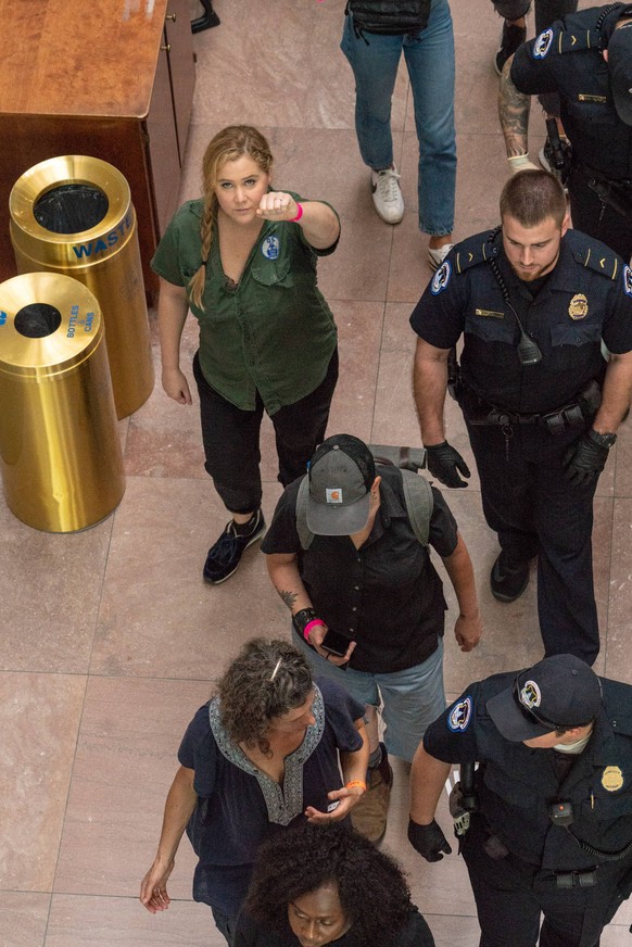 Comedian Amy Schumer raises her fist after getting detained along with hundreds of other protestors against the confirmation of Supreme Court nominee Judge Brett Kavanaugh in the Hart Senate Office Bu ...