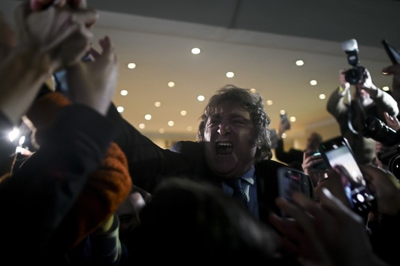 Javier Milei, presidential candidate of the Liberty Advances coalition, greets followers outside his campaign headquarters after polling stations closed during primary elections in Buenos Aires, Argen ...