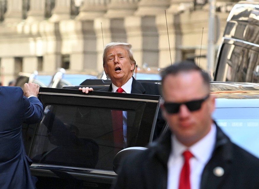 March 25, 2024, New York, New York, USA: Former President Trump steps out of 40 Wall Street following his presser on his very busy day of legal issues. Huge crowds of downtown tourists and pedestrians ...