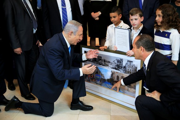 Israeli Prime Minister Benjamin Netanyahu and Jerusalem Mayor Nir Barkat look at old and new photos of Jerusalem, ahead of a special cabinet meeting marking Jerusalem Day, at the Bible Lands Museum in ...