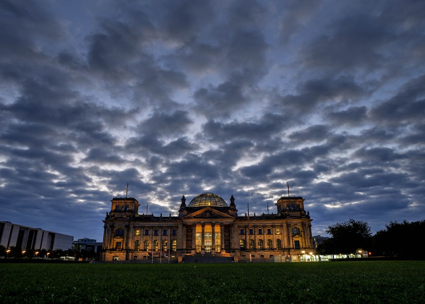 Clouds drift over the Reichstag building with the German parliament in Berlin, Germany, Sunday, Sept. 26, 2021. German elections are held on Sunday. (AP Photo/Michael Probst)