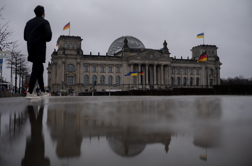 An Ukrainian flag waves on the top and in the front of the German parliament building, the Reichstag building, to mark the first anniversary of Russia&#039;s full-scale invasion of Ukraine, in Berlin, ...