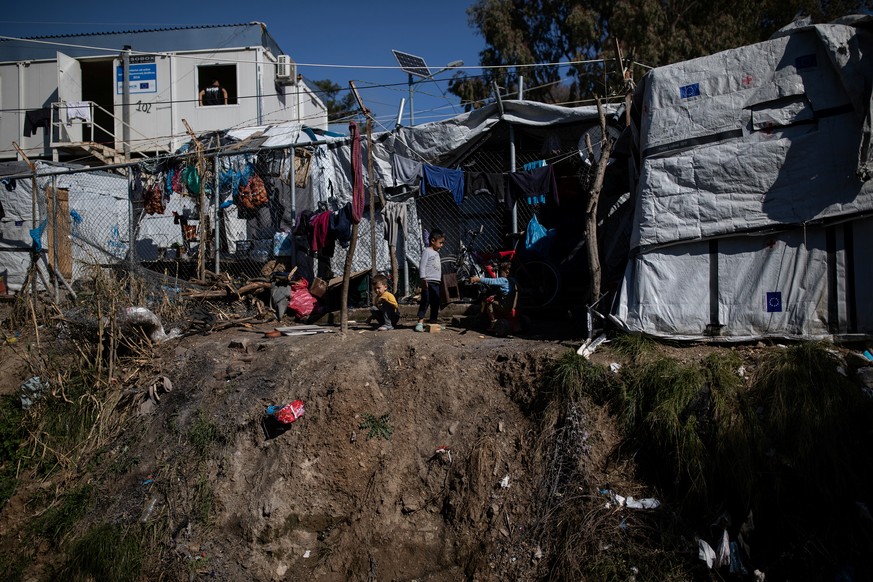 Children play next to the fence of the Moria migrant camp on the island of Lesbos, Greece, February 18, 2020. Picture taken February 18, 2020. REUTERS/Alkis Konstantinidis