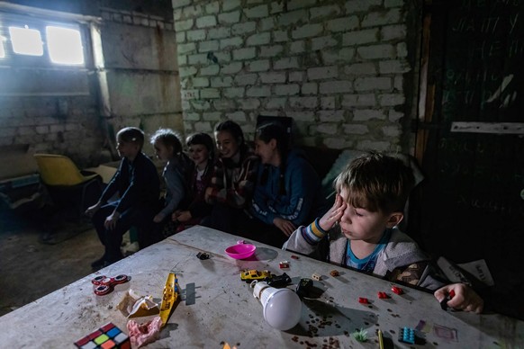 May 26, 2022, Lysychansk, Ukraine: A boy plays with toys at an underground bomb shelter. As Russian troops launch the offensive from multiple directions, hoping to cut off Ukrainian supplies and reinf ...