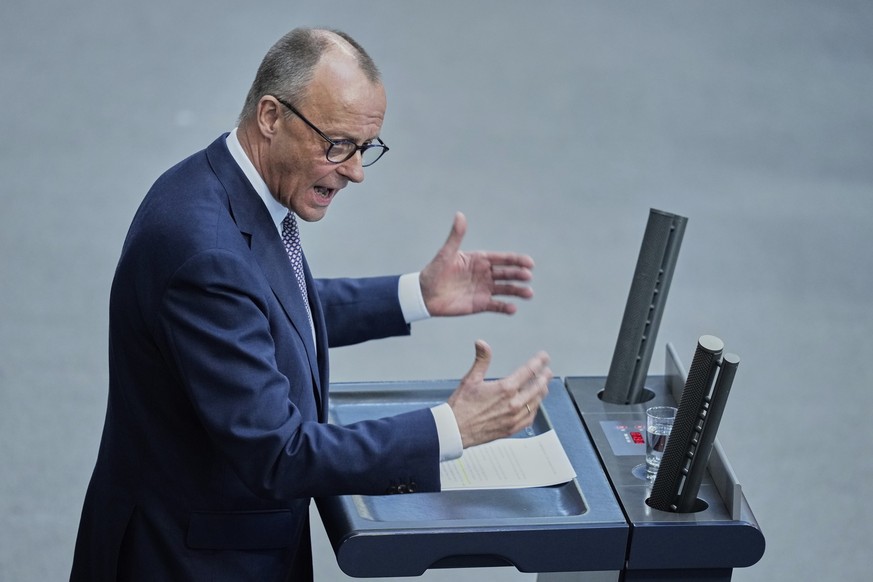 German opposition leader and Christian Democratic Union party chairman Friedrich Merz, right, speaks during a debate and voting about loosen the country&#039;s debt rules and change constitution in th ...