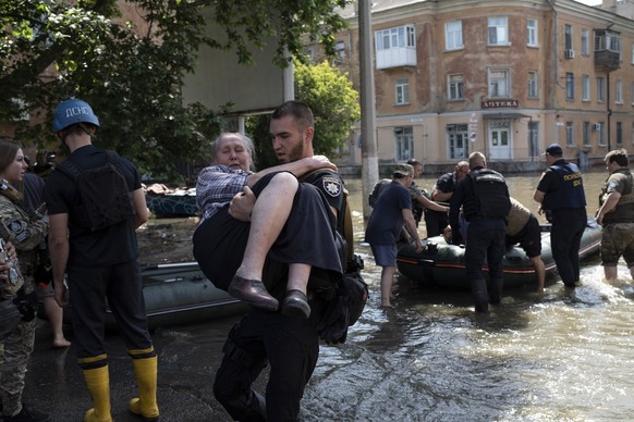 Residents are evacuated from a flooded neighborhood in Kherson, Ukraine, Wednesday, June 7, 2023 after the Kakhovka dam was blown up. Residents of southern Ukraine braced for a second day of swelling  ...