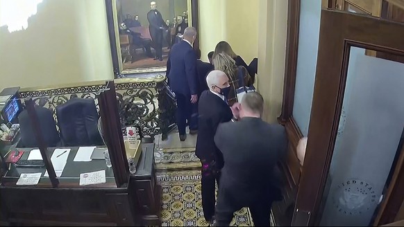 In this image from video released by the House Select Committee, Vice President Mike Pence looks is evacuated from the second floor of the Capitol on Jan. 6, that is displayed as House select committe ...