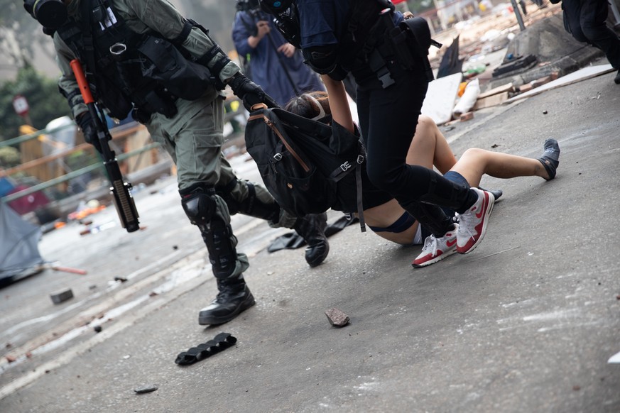 November 18, 2019, Hong Kong, China: Police officers drag a protester from the ground during the demonstration..Police surround the Polytechnic University after pro-democratic protesters blocked the c ...