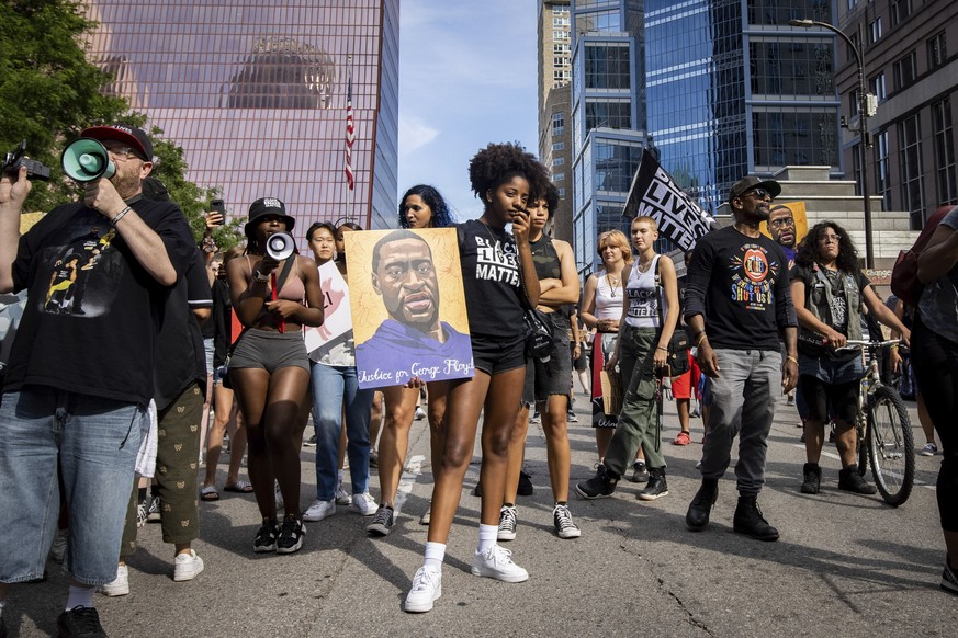 Protesters get ready to march outside of the Hennepin County Government Center after former Minneapolis police officer Derek Chauvin was sentenced to 22.5 years in prison for the murder of George Floy ...