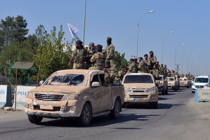 191010 -- ANKARA, Oct. 10, 2019 -- Members of the Syrian National Army head for Ras al-Ain in northern Syria from the southern Turkish border town of Ceylanpinar, Oct. 10, 2019. Turkish Armed Forces o ...