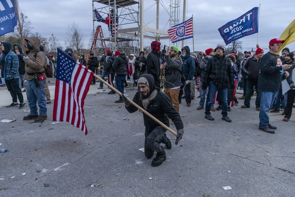 Pro-Trump Riot in Washington DC Trump supporter prays in front of Capitol building where pro-Trump supporters riot and breached the Capitol. Rioters broke windows and breached the Capitol building in ...