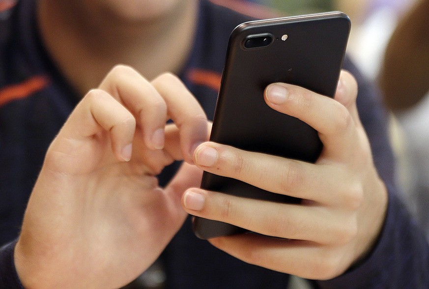 FILE - A person uses a smartphone in Chicago, Sept. 16, 2017. Most Democrats and Republicans agree that the federal government should better regulate the biggest technology companies, particularly soc ...