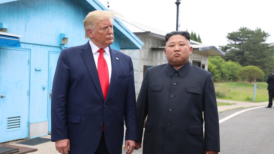 PANMUNJOM, SOUTH KOREA - JUNE 30 (SOUTH KOREA OUT): A handout photo provided by Dong-A Ilbo of North Korean leader Kim Jong Un and U.S. President Donald Trump inside the demilitarized zone (DMZ) separ ...