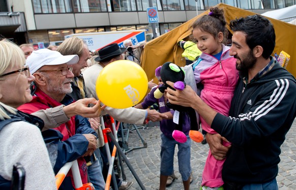 Flüchtlinge werden am Münchener Hauptbahnhof empfangen. 2015 war das Jahr des Slogans &quot;Refugees Welcome&quot;.