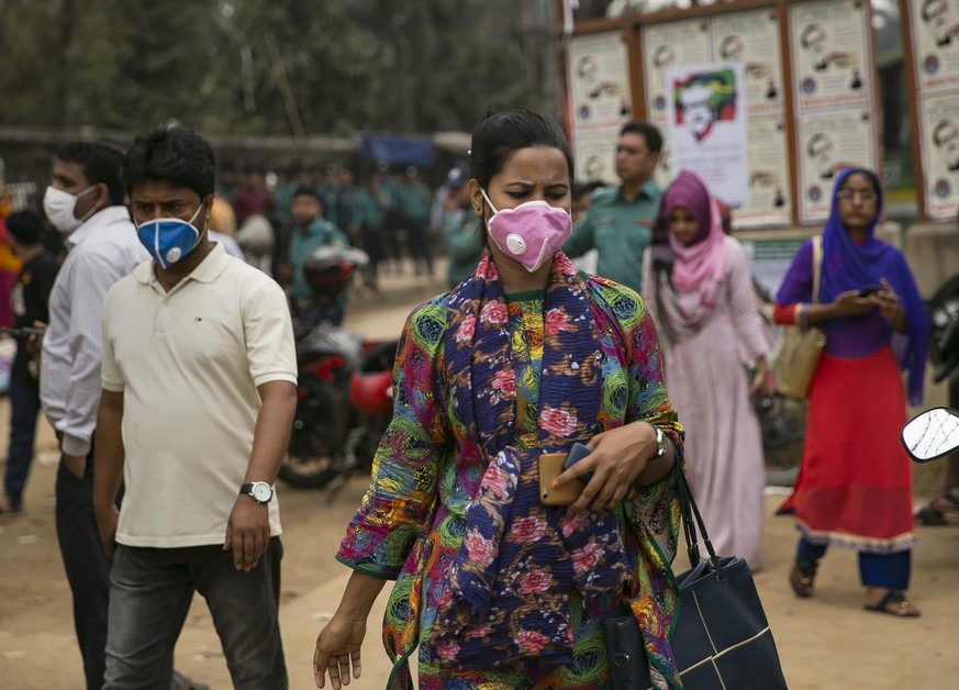DHAKA, BANGLADESH - MARCH 08: A woman wears a face mask amid a global coronavirus outbreak at a Women's Day rally March 8, 2020 in Dhaka, Bangladesh. International Women's Day is observed on March 8 e ...