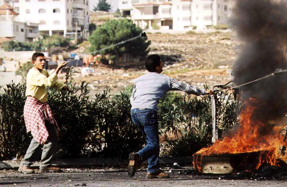 Palästinensische Jugendliche mit Schleudern während eines Straßenkampfes in Ramallah.