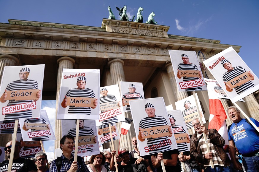 People attend a protest rally in Berlin, Germany, Saturday, Aug. 29, 2020 against new coronavirus restrictions in Germany. Police in Berlin have requested thousands of reinforcements from other parts  ...