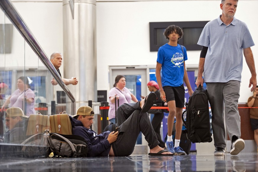 Andrew Colwell waits on his fourth rebooked flight as he tries to get home to Denver from Hartsfield Jackson International Airport in Atlanta Friday, July 19, 2024, as a major internet outage affectin ...