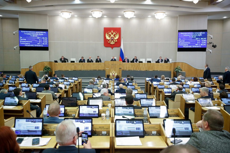 In this handout photo provided by The State Duma, The Federal Assembly of The Russian Federation, Russian lawmakers attend a session of the State Duma, the Lower House of the Russian Parliament in Mos ...